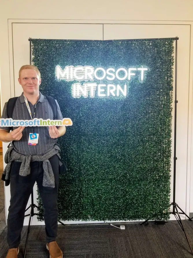 A picture of myself holding up a #intern banner.